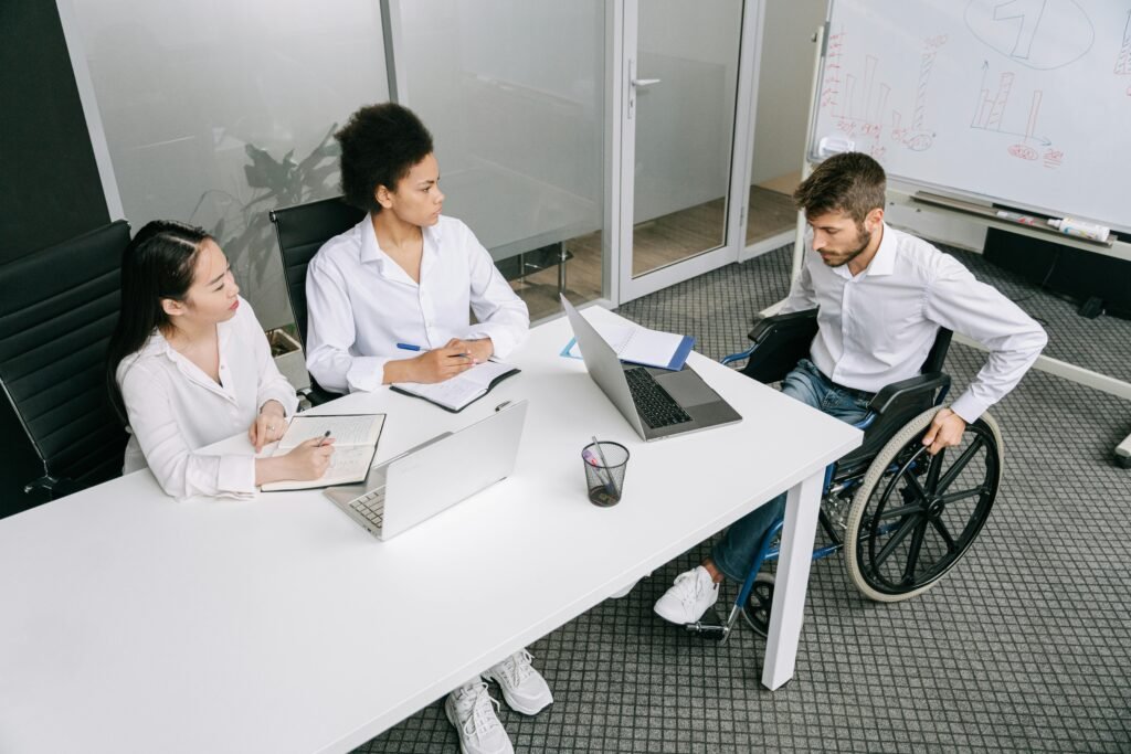 A diverse group of colleagues in a business meeting discussing ideas indoors.