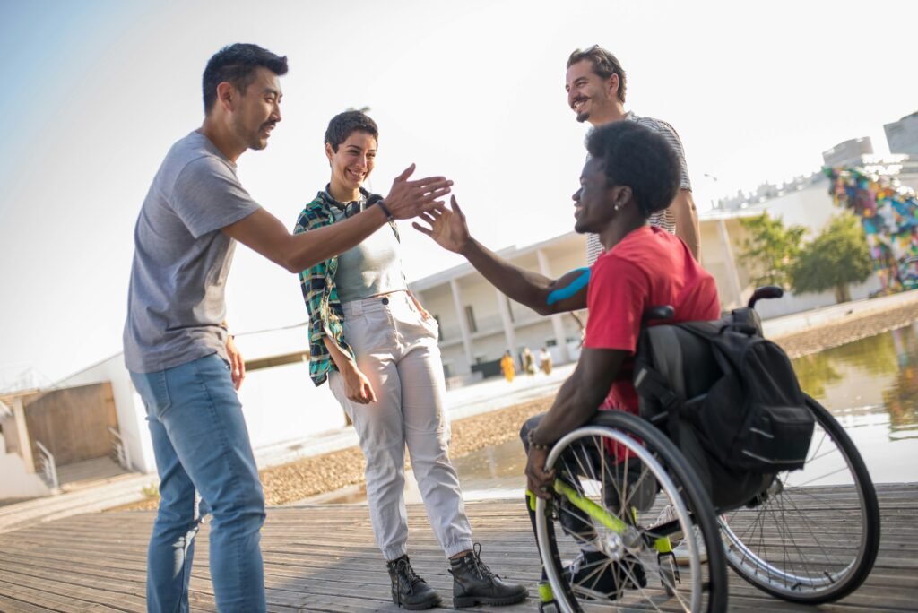 Friends greet each other outdoors in Portugal, promoting diversity and inclusion.